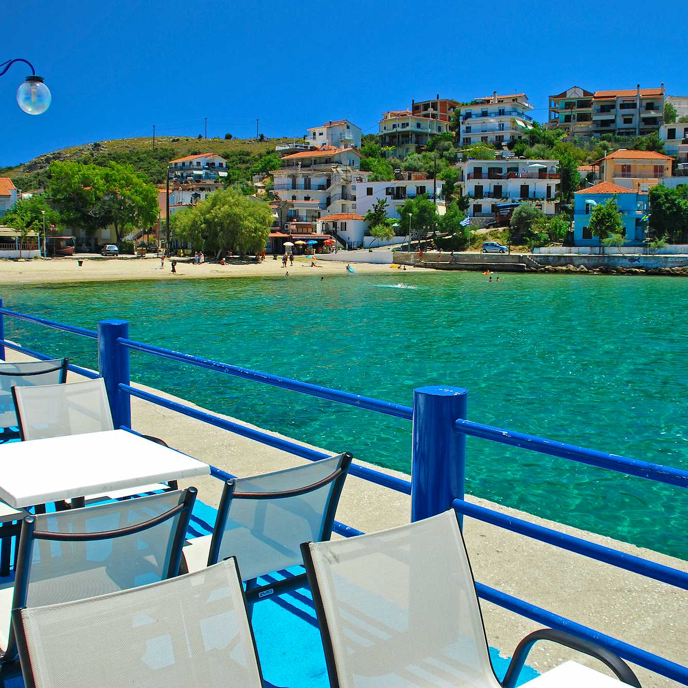 Photo Caption: Tavernas and cafes stretch along the coastline