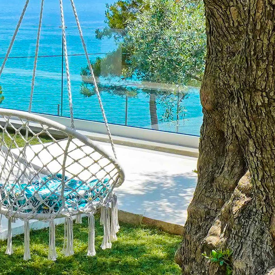 Photo Caption: Swing under an ancient olive tree and float above the Aegean