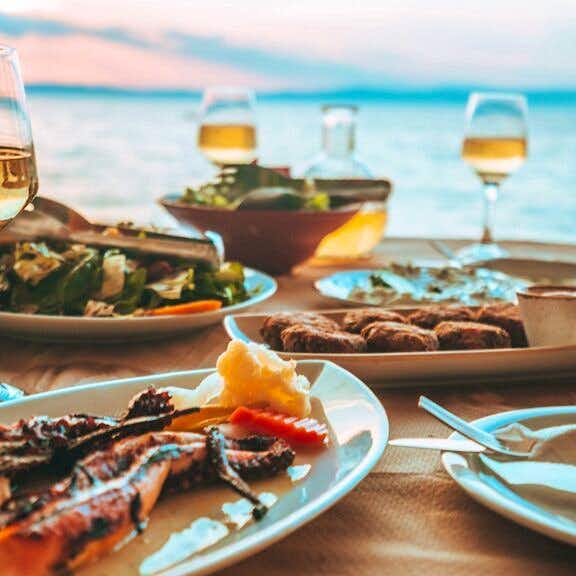 Photo Caption: Enjoy fresh seafood & wine in nearby tavernas
