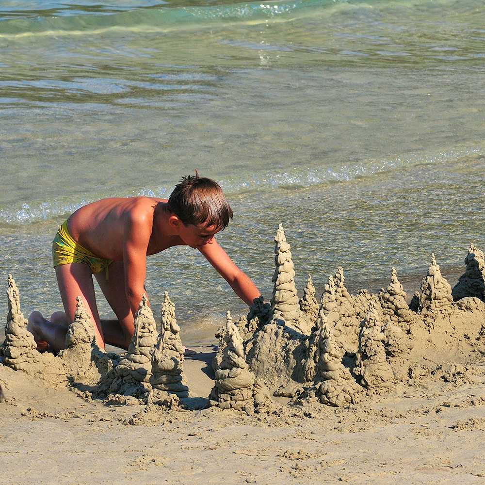 Photo Caption: Watch the kids play and enjoy the fine sand and shallow water